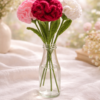 Whispers of Spring – Crochet Carnations (Set of 4)_1 Handmade crochet carnation bouquet in soft pink, red and white tones arranged in a glass vase with a light pastel spring background
